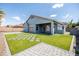Spacious backyard featuring well-manicured artificial turf, paver accents, and a covered patio at 4140 E Claxton Ave, Gilbert, AZ 85297