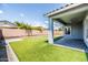 A covered patio overlooks artificial turf grass with paver accents in the well-maintained backyard at 4140 E Claxton Ave, Gilbert, AZ 85297