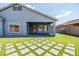 View of the backyard with covered patio, artificial turf, and paver accents at 4140 E Claxton Ave, Gilbert, AZ 85297