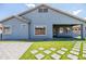 Artificial turf in the backyard with stepping stones leading to the house and covered patio at 4140 E Claxton Ave, Gilbert, AZ 85297