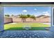 Private backyard oasis with manicured artificial turf, desert landscaping, paved patio, and block wall at 4140 E Claxton Ave, Gilbert, AZ 85297