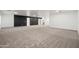Finished basement with neutral carpet, dark accent wall and ample room for customization at 4140 E Claxton Ave, Gilbert, AZ 85297