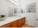 Bathroom features a large mirror, wood cabinets, and decorative wall art at 4140 E Claxton Ave, Gilbert, AZ 85297