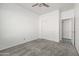 Bright bedroom featuring neutral carpet, a ceiling fan and closet for ample storage at 4140 E Claxton Ave, Gilbert, AZ 85297