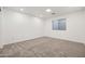 Neutral bedroom features plush carpeting, recessed lighting, and a bright window illuminating the space at 4140 E Claxton Ave, Gilbert, AZ 85297