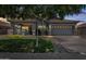 Charming single-Gathering home with lush green lawn and warm exterior lighting at 4140 E Claxton Ave, Gilbert, AZ 85297