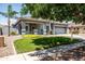 Charming single-Gathering home with lush green lawn and desert landscaping at 4140 E Claxton Ave, Gilbert, AZ 85297