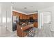 Spacious kitchen featuring an island with bar seating, wood cabinets, granite counters, and stainless steel appliances at 4140 E Claxton Ave, Gilbert, AZ 85297