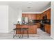 Modern kitchen with dark wood cabinets, granite counters, and stainless steel appliances at 4140 E Claxton Ave, Gilbert, AZ 85297