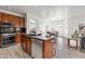 Well-equipped kitchen with stainless steel appliances, a center island, wood cabinets, and an open floor plan at 4140 E Claxton Ave, Gilbert, AZ 85297