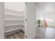 Walk-in pantry with ample shelving and an open door, located near the kitchen and upstairs landing at 4140 E Claxton Ave, Gilbert, AZ 85297
