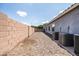 This side yard features low maintenance gravel, a block wall, and multiple AC units at 4140 E Claxton Ave, Gilbert, AZ 85297