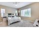 Comfortable carpeted bedroom with large windows, ceiling fan, and built-in media center providing cozy relaxation at 4630 E Navigator Ln, Phoenix, AZ 85050