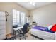 Neutral bedroom features desk with chair, and window with blinds for a relaxing home office at 4630 E Navigator Ln, Phoenix, AZ 85050
