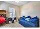 Bright bedroom features a daybed with cozy pillows, and a window with blinds at 4630 E Navigator Ln, Phoenix, AZ 85050