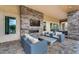 Inviting outdoor living space with cozy seating, stone fireplace, TV and stylish, durable patio furniture at 4630 E Navigator Ln, Phoenix, AZ 85050