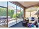 Screened-in porch offers a relaxing retreat with wicker furniture and view of a landscaped backyard at 4630 E Navigator Ln, Phoenix, AZ 85050