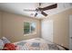 Bright bedroom with a patterned quilt, a ceiling fan, and natural light from the window at 4743 E Laurel Ave, Gilbert, AZ 85234