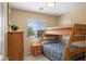 Charming ' bedroom featuring bunk beds, a side table, and natural light at 4743 E Laurel Ave, Gilbert, AZ 85234