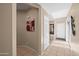 Spacious hallway with tiled flooring, leading to various rooms and featuring decorative wall art at 4743 E Laurel Ave, Gilbert, AZ 85234