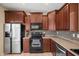 Traditional kitchen with stainless steel appliances, dark wood cabinets and tile backsplash at 4743 E Laurel Ave, Gilbert, AZ 85234