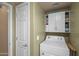 Efficient laundry area equipped with a washer, dryer, and overhead cabinets for organized storage solutions at 4743 E Laurel Ave, Gilbert, AZ 85234