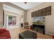 Inviting living room featuring wood floors, a modern TV, and sliding door access to an outdoor space at 4743 E Laurel Ave, Gilbert, AZ 85234
