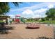 Community playground featuring swings, slides, and various play structures, perfect for Gathering fun and recreation in a safe environment at 4743 E Laurel Ave, Gilbert, AZ 85234