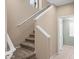 Carpeted staircase with white railings, ascending to the upper level and a view of the hallway below at 4743 E Laurel Ave, Gilbert, AZ 85234