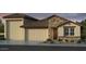 Inviting single-story home showcasing a beautiful stone facade and a spacious three-car garage at 5208 W Jackalope Ln, Laveen, AZ 85339