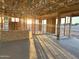Living room area framed with wooden beams, overlooking the construction site, waiting to become a beautiful home at 5512 W Piedmont Rd, Laveen, AZ 85339