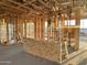 Sunlit living room featuring the wooden framing, showcasing the construction of this modern home at 5512 W Piedmont Rd, Laveen, AZ 85339