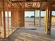 Living room area framed with wooden beams, overlooking the construction site, waiting to become a beautiful home at 5512 W Piedmont Rd, Laveen, AZ 85339