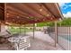 Backyard patio area covered in string lights and open lawn next to fenced-in pool at 5861 E Anderson Dr, Scottsdale, AZ 85254