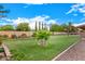 Lush backyard featuring a manicured lawn, mature trees, and a privacy fence, offering a serene outdoor space at 5861 E Anderson Dr, Scottsdale, AZ 85254