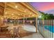Backyard patio area covered in string lights next to fenced-in pool at 5861 E Anderson Dr, Scottsdale, AZ 85254