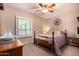 Cozy bedroom with a decorative wall hanging and a classic wood frame bed at 5861 E Anderson Dr, Scottsdale, AZ 85254