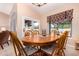 A dining room with a wood table and chairs, alongside windows and a sliding door at 5861 E Anderson Dr, Scottsdale, AZ 85254