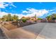 View of home exterior featuring a large driveway and desert landscaping at 5861 E Anderson Dr, Scottsdale, AZ 85254