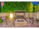 Cozy outdoor seating area with a brick fire pit, swing and chairs, ideal for entertaining or relaxing at night at 5861 E Anderson Dr, Scottsdale, AZ 85254