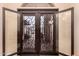 Ornate wrought iron double front door with decorative glass at 5861 E Anderson Dr, Scottsdale, AZ 85254