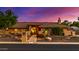 Charming home exterior with manicured landscaping, pathway lighting, and a warm, inviting entrance at 5861 E Anderson Dr, Scottsdale, AZ 85254