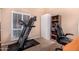 Carpeted home gym includes a treadmill, storage cabinet and comfy chair at 5861 E Anderson Dr, Scottsdale, AZ 85254