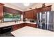 This modern kitchen features stainless steel appliances, an island, and a garden view at 5861 E Anderson Dr, Scottsdale, AZ 85254