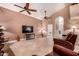 A spacious living room featuring a large sofa, tile floors, ceiling fans, and recessed lighting at 5861 E Anderson Dr, Scottsdale, AZ 85254