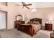 A large main bedroom with a ceiling fan, a dresser, and a sitting area at 5861 E Anderson Dr, Scottsdale, AZ 85254