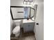 Updated bathroom featuring a modern vanity with a framed mirror and a tiled floor at 5975 N 48Th Dr, Glendale, AZ 85301