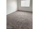 Comfortable bedroom featuring neutral carpeting, a window, and freshly painted walls at 5975 N 48Th Dr, Glendale, AZ 85301