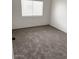 Inviting bedroom featuring neutral carpeting, a window, and freshly painted walls at 5975 N 48Th Dr, Glendale, AZ 85301