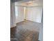Bright bedroom featuring tile flooring, a window with blinds, and neutral walls for a serene living space at 5975 N 48Th Dr, Glendale, AZ 85301